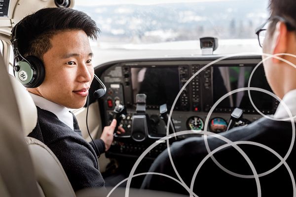 Student sitting in the cockpit of a plane