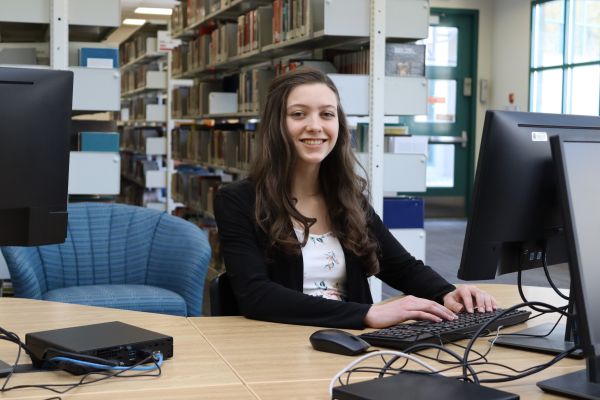 Business student sitting at computer in library